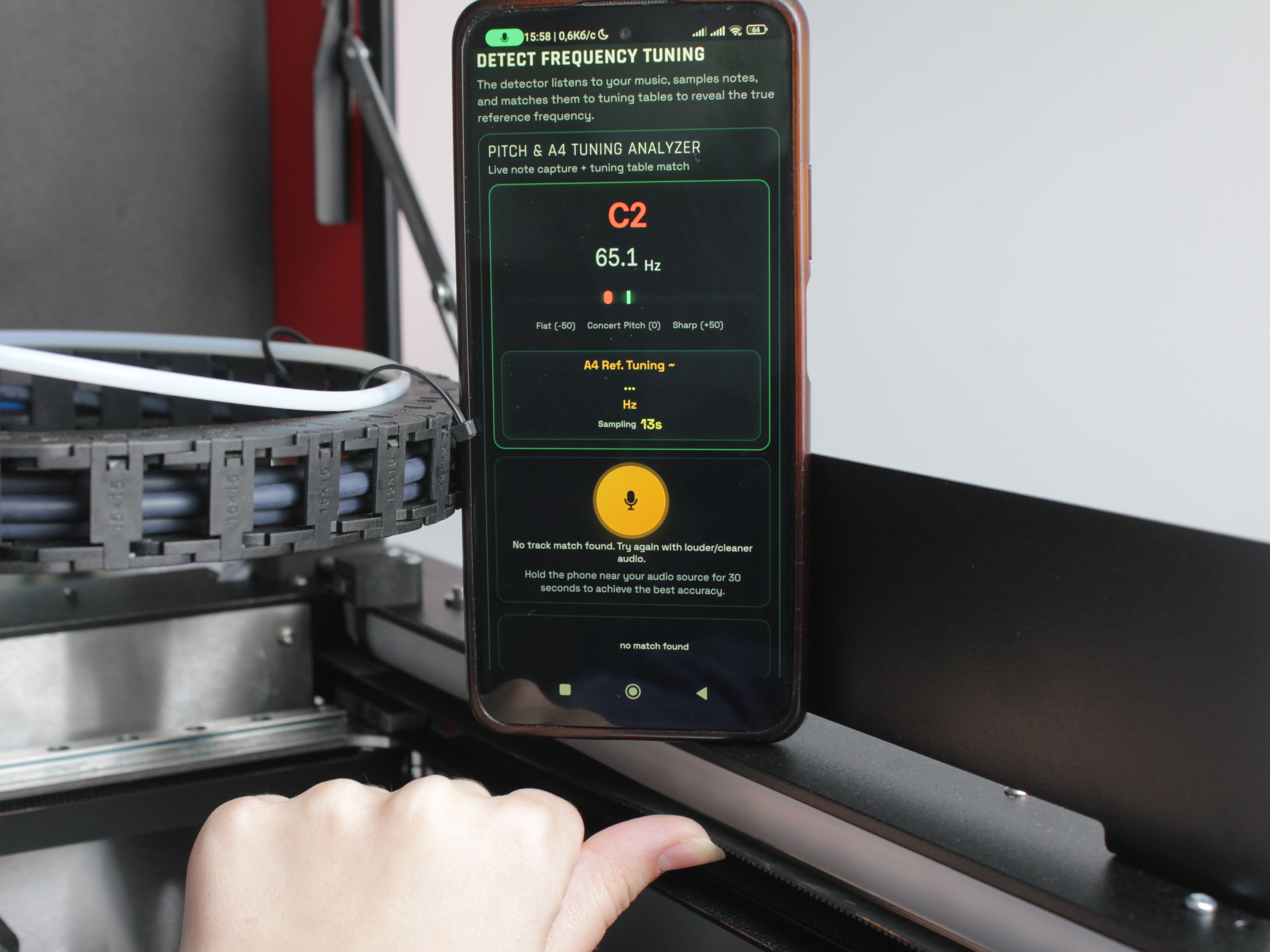 Guitar tuning app displaying 65 Hz - correct Y-axis belt tension