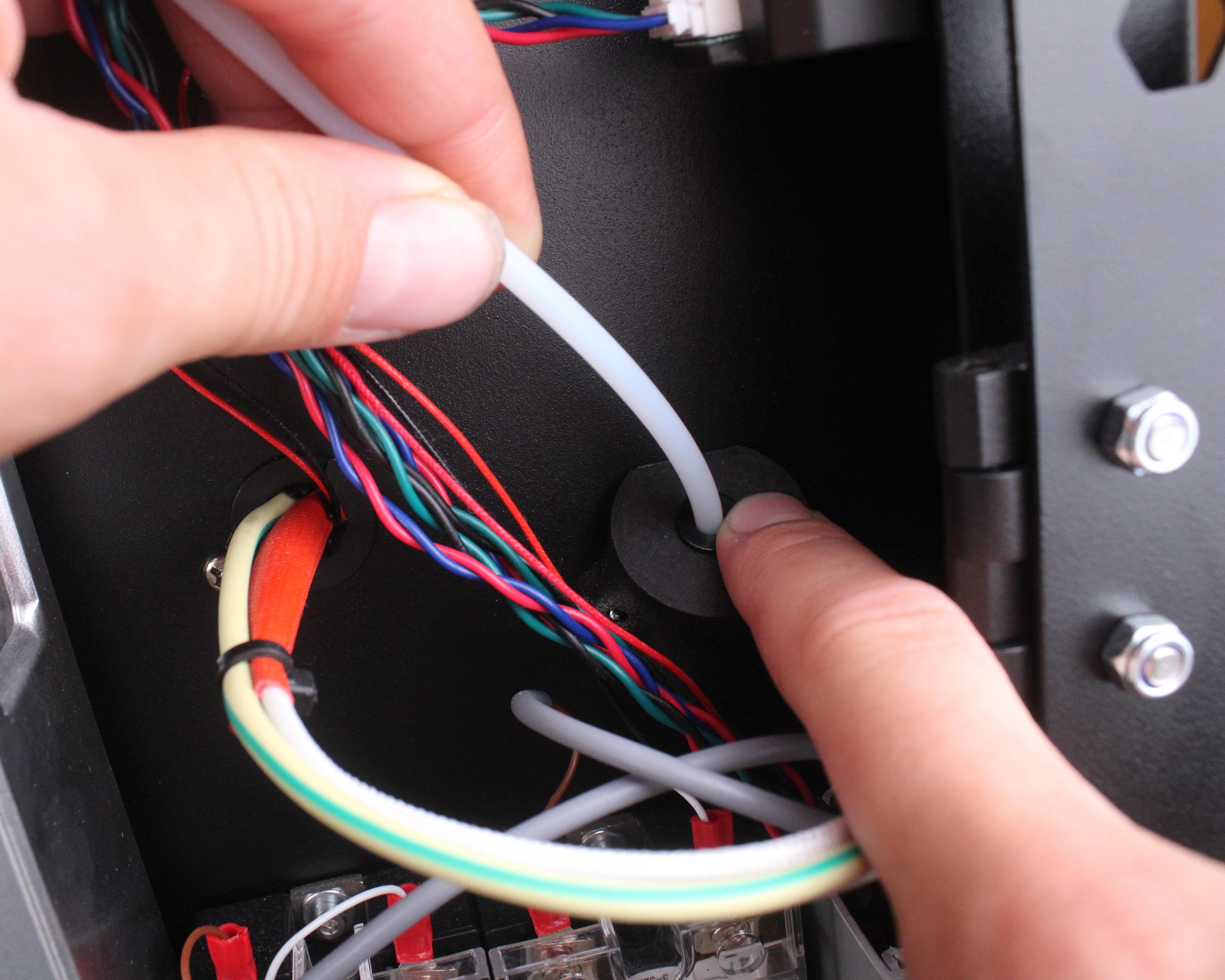 Push-fit clip at rear wall filament entry point.