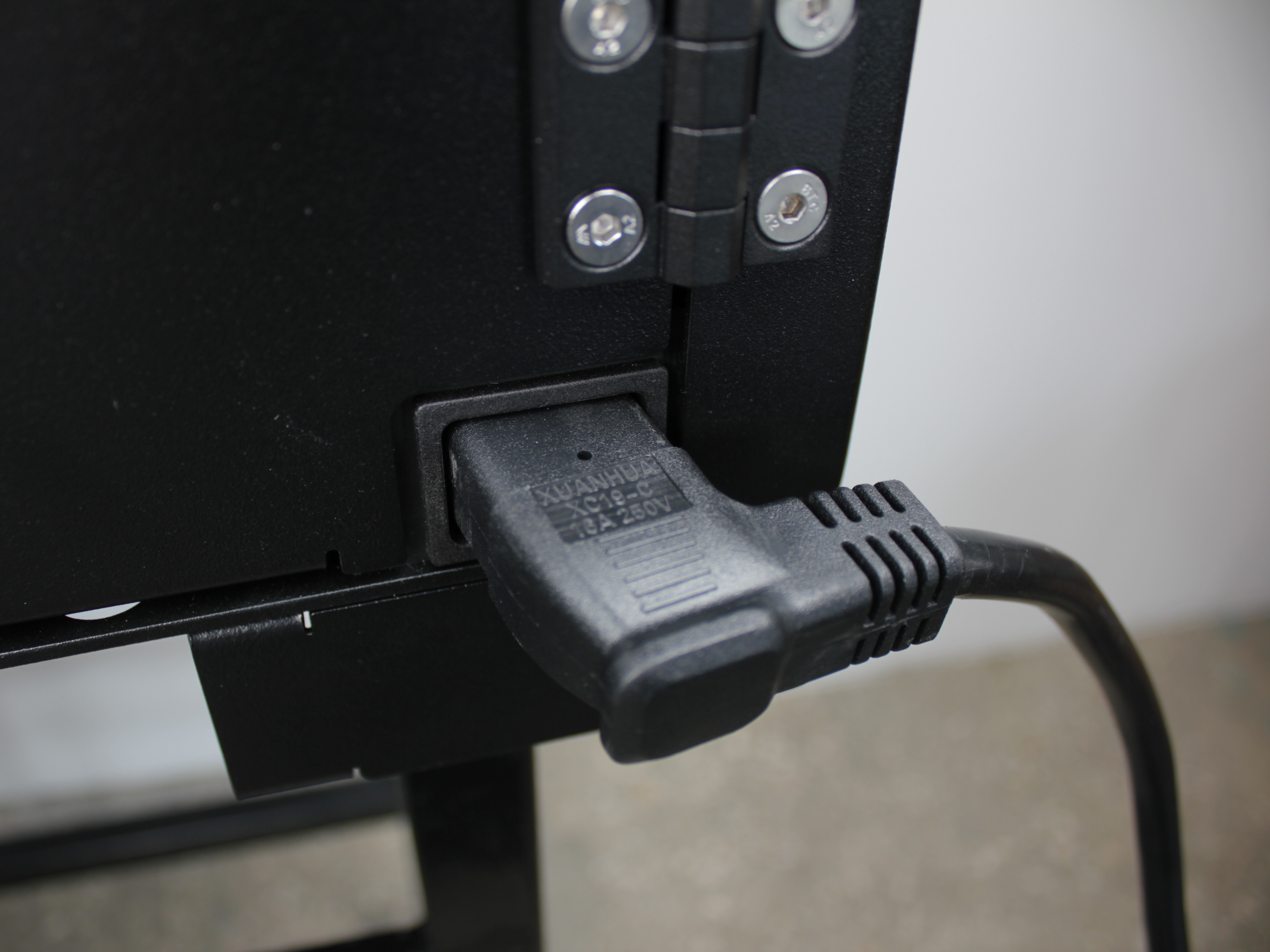 Incorrect power cable insertion - NEMA 5-15p cable partially inserted into rear panel inlet showing visible gap