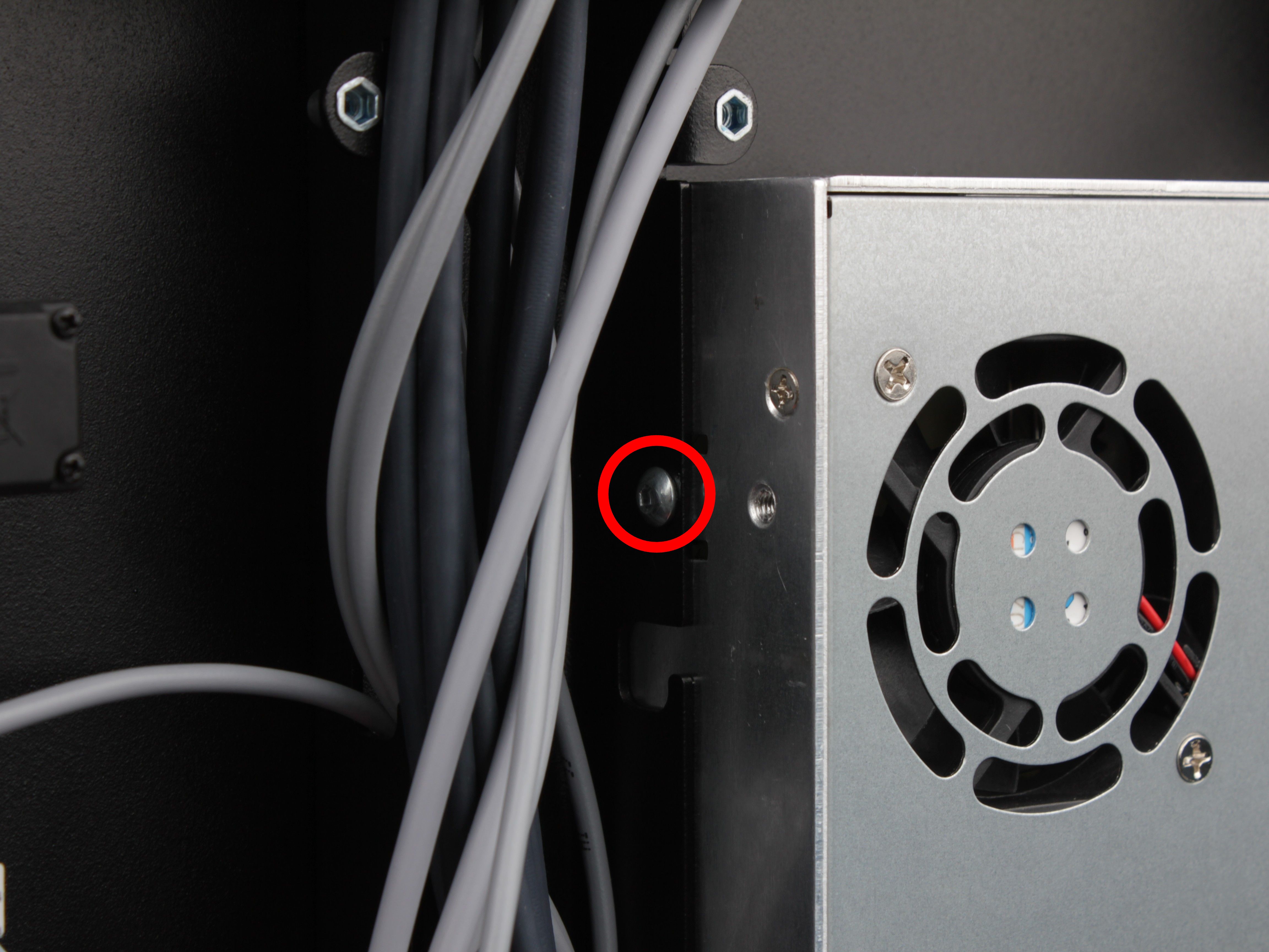 Upper PSU mounting screw on the left side