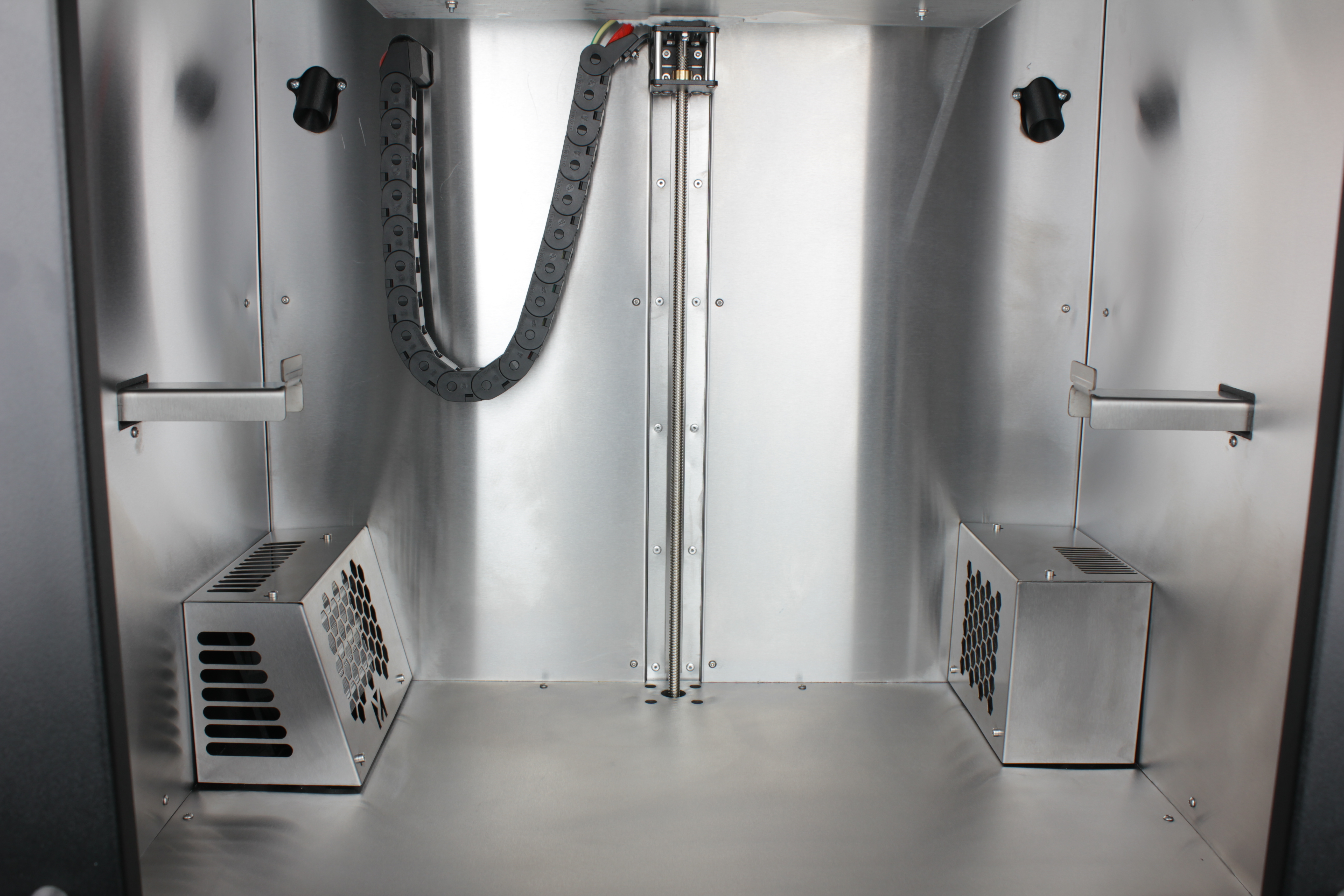 Build plate raised \u2014 open space inside the enclosure from the front