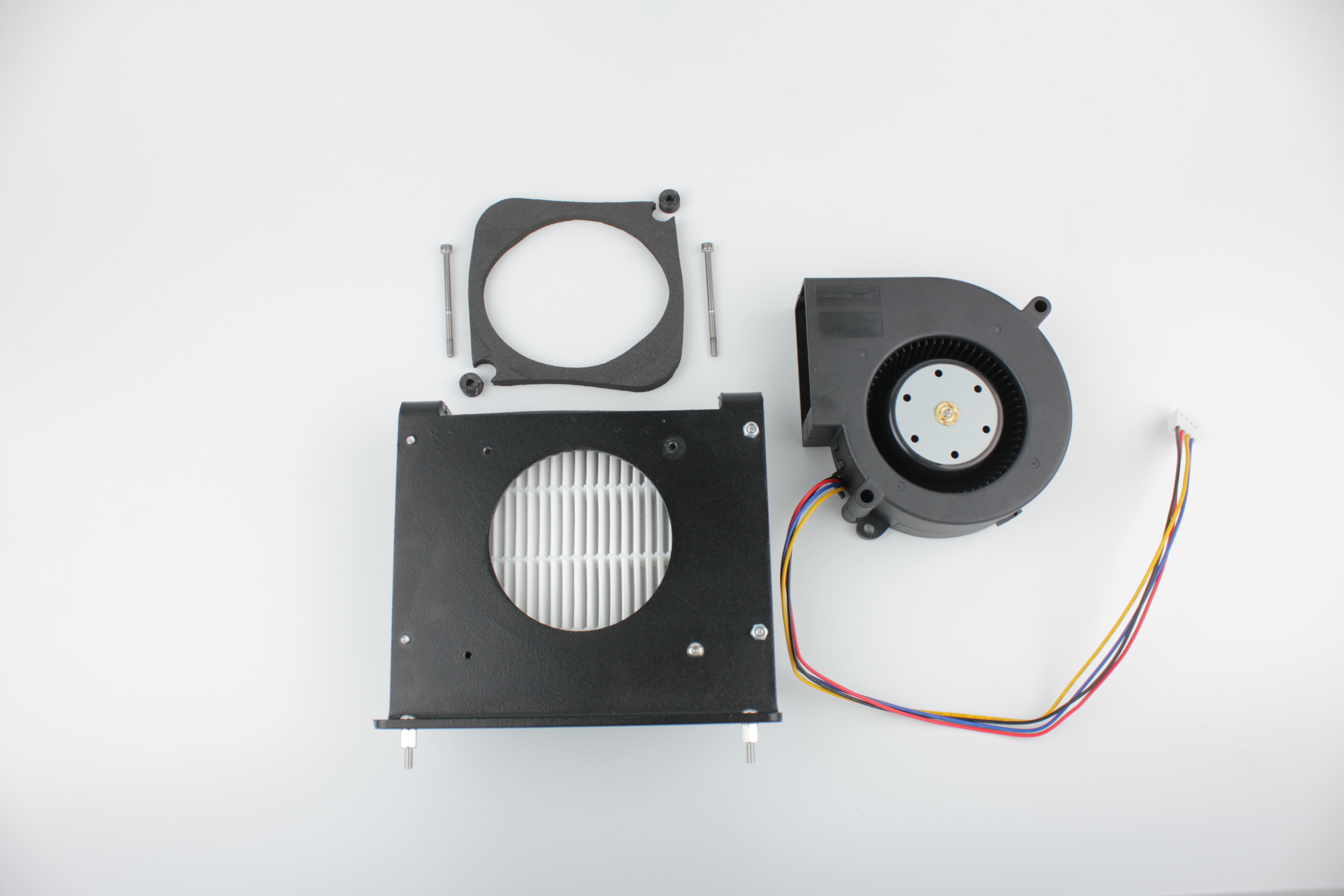 Fan removed \u2014 spacers and gasket layout next to bracket ears