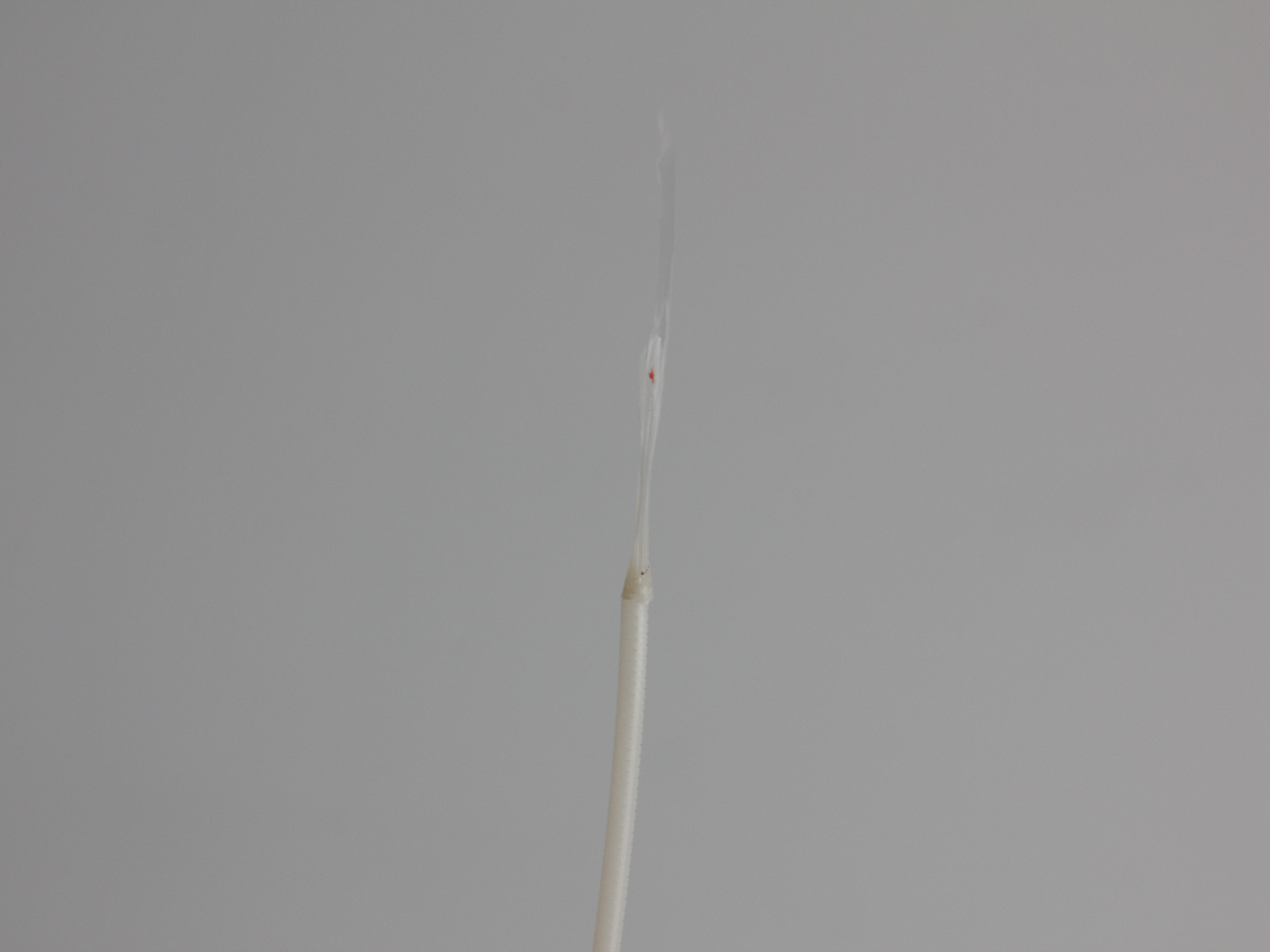 Clean filament tip after successful cold pull showing no contamination or debris - the key indicator of a successful procedure