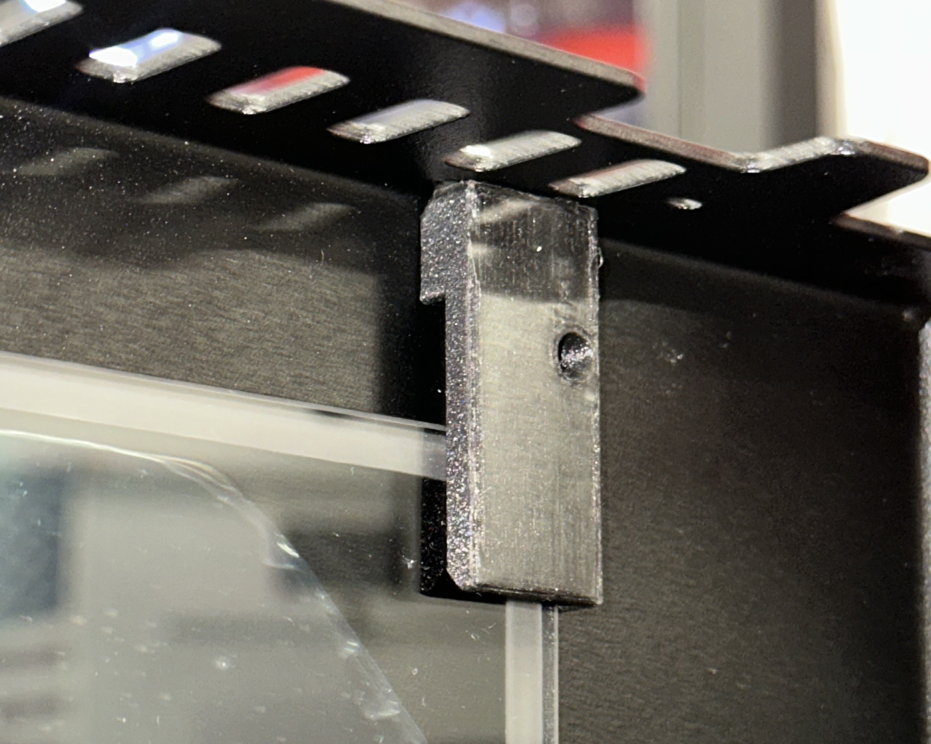 Left top corner of the glass frame showing the longer bracket