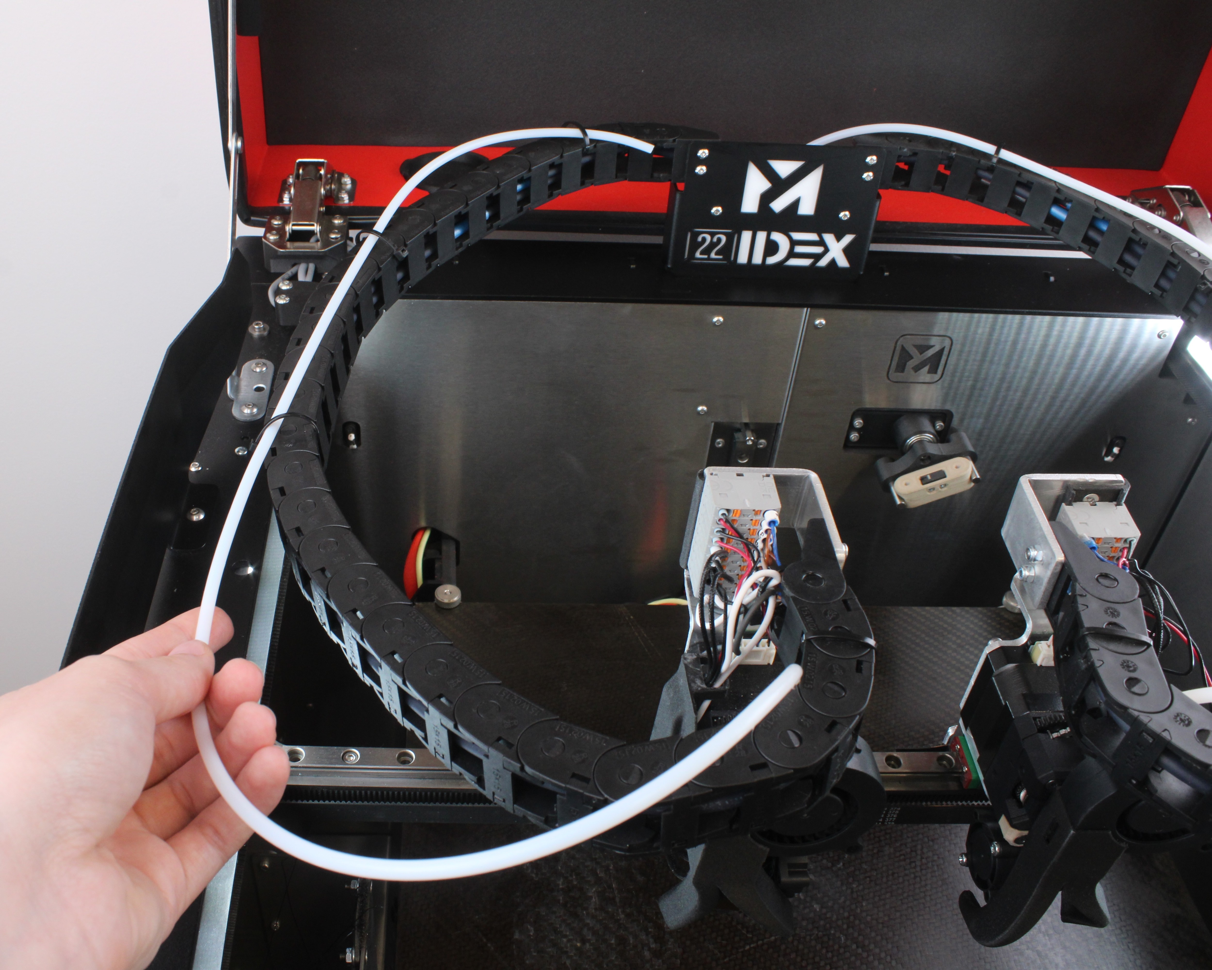 Pulling the old PTFE tube out of the cable chain clips and zip ties.