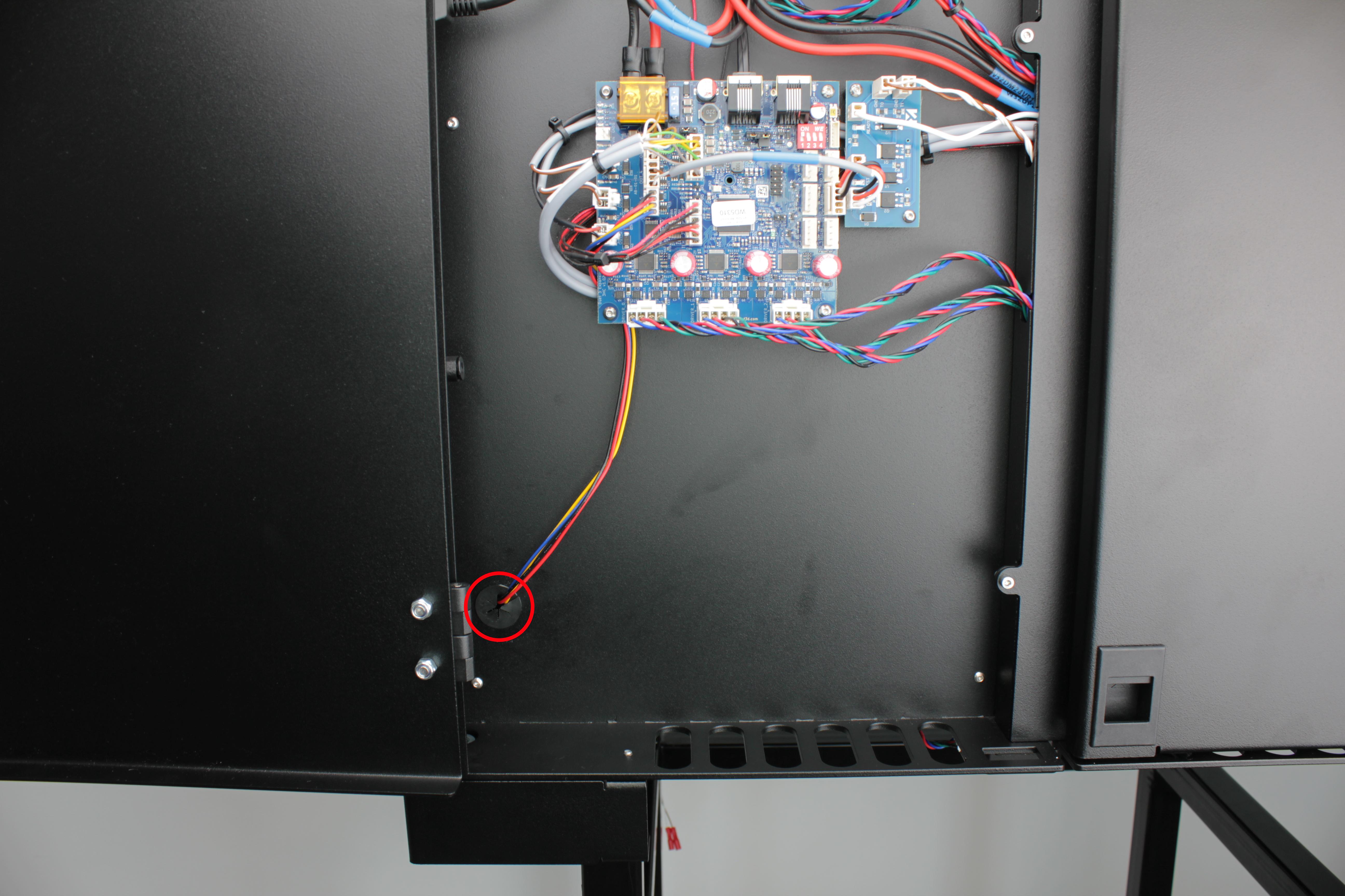 Cable grommet in enclosure wall \u2014 slit visible