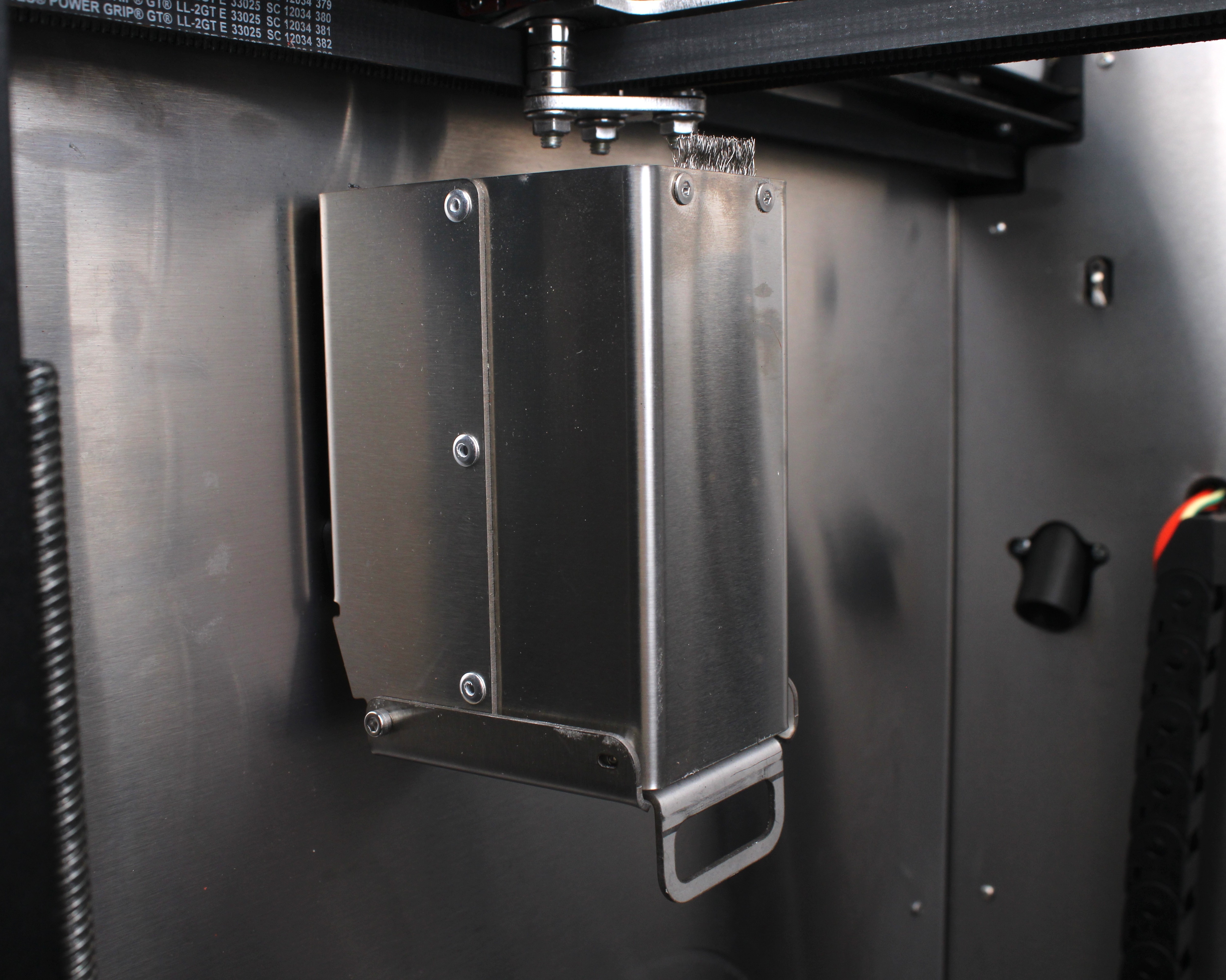 Purge bucket mounted inside the printer with the wiping brush installed on top