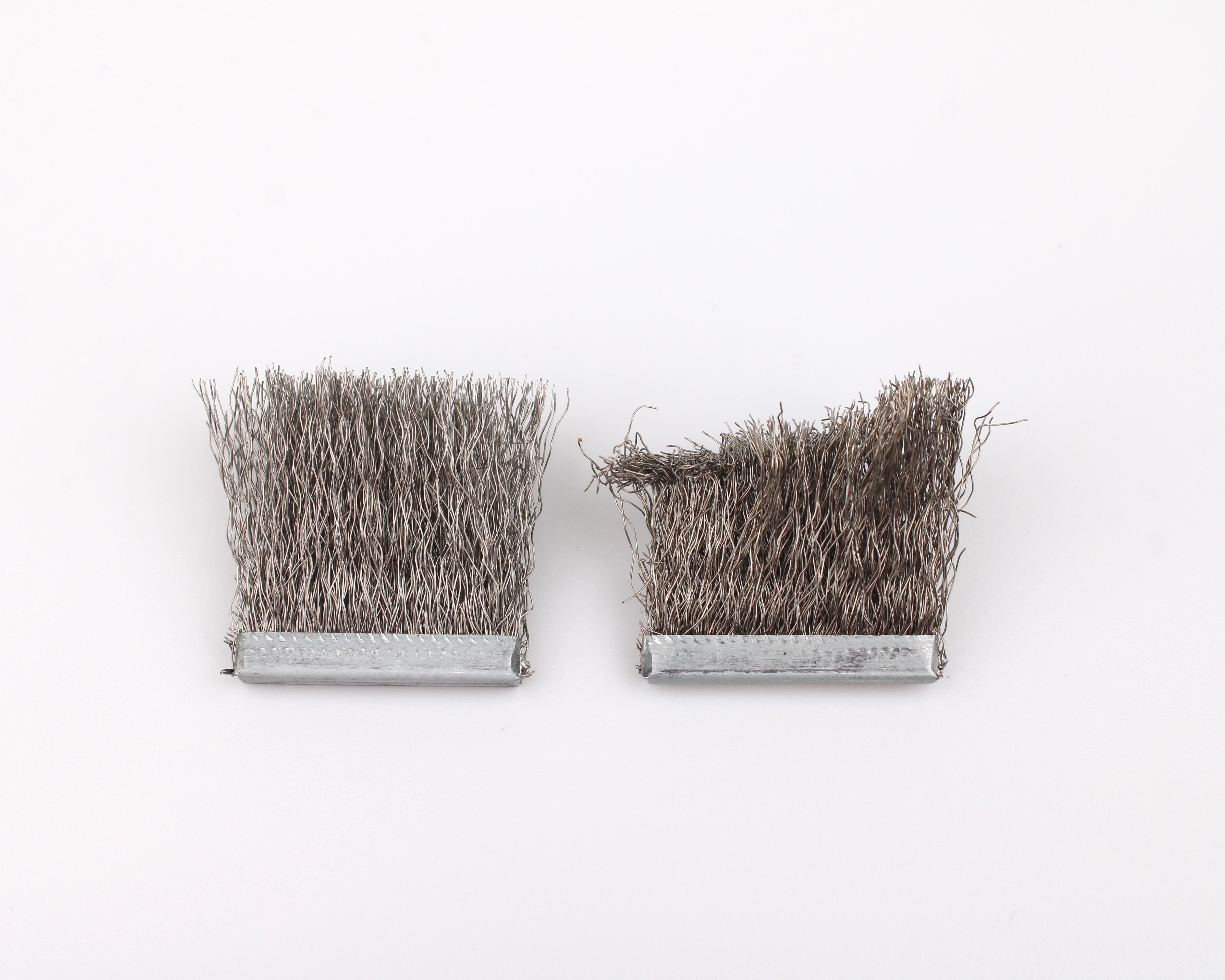 New brush with even bristles next to a worn brush with flattened, tangled bristles