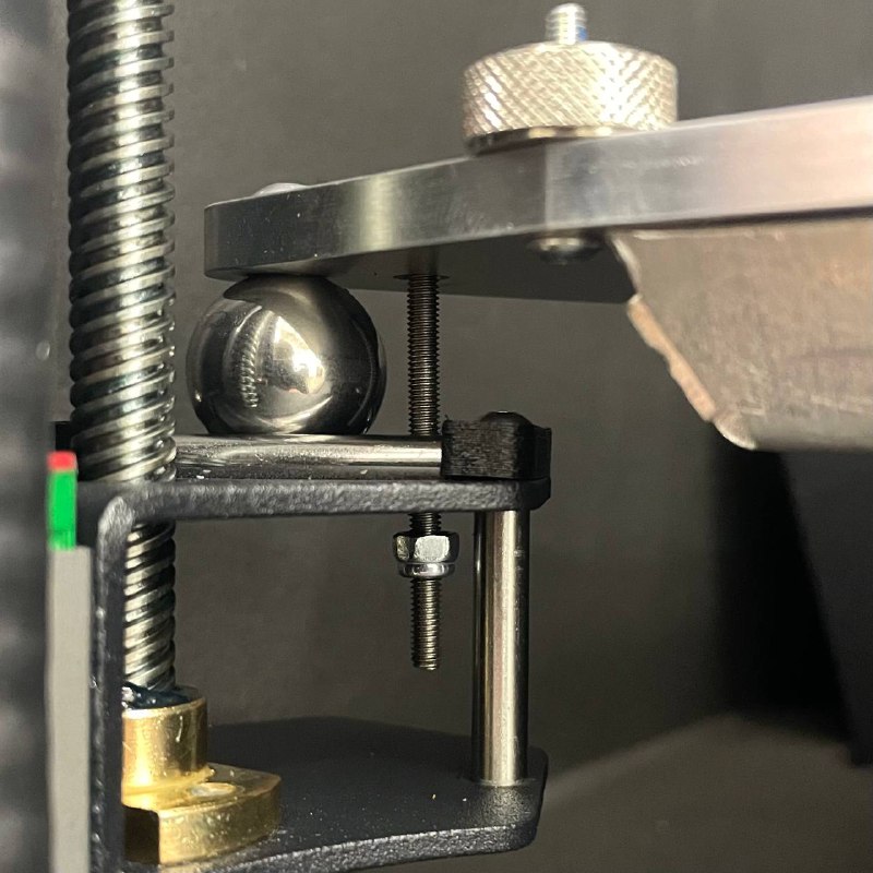 Loosening the front left bed mounting screw