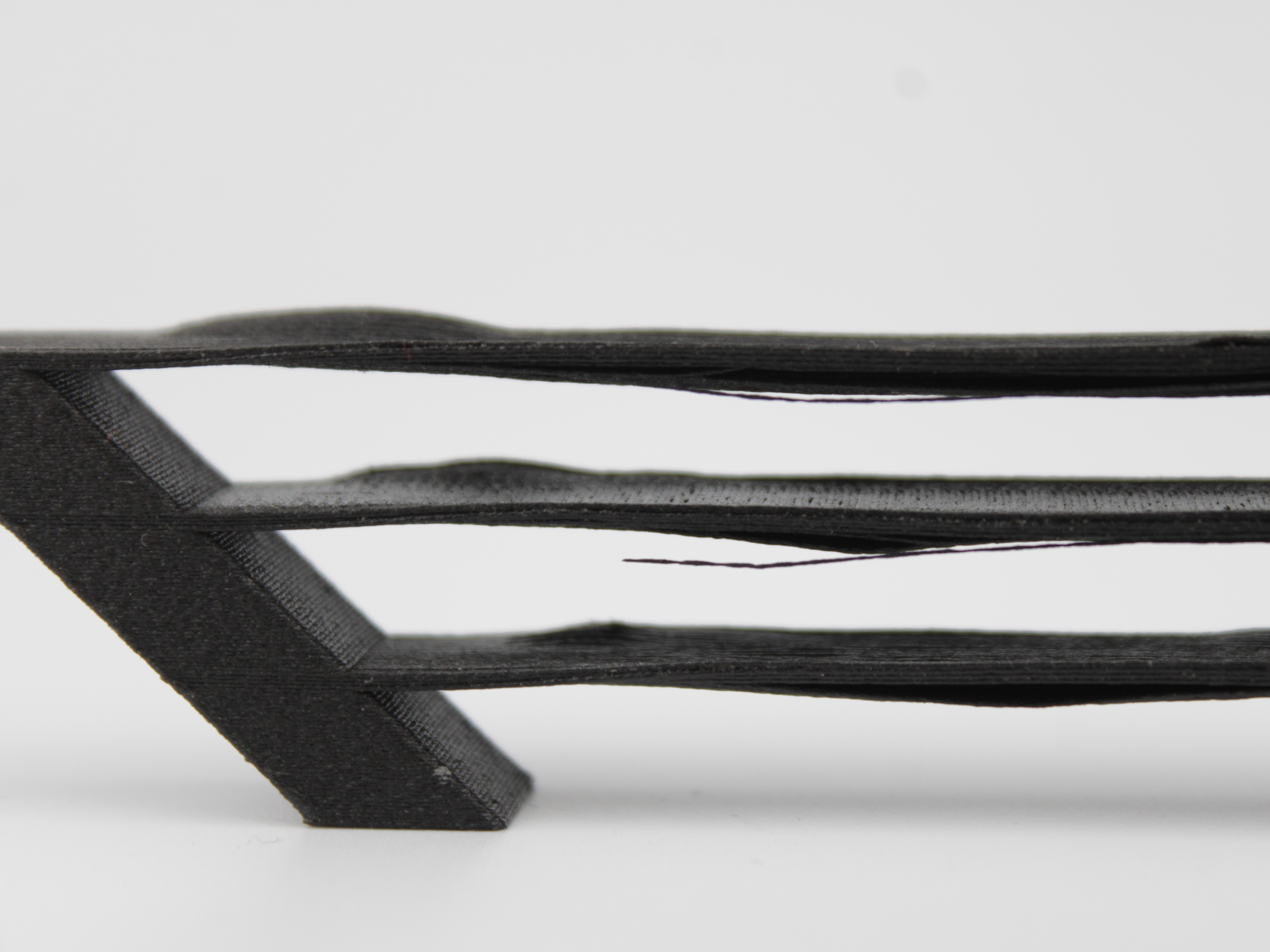 Broken bridge with gaps showing incomplete filament strands