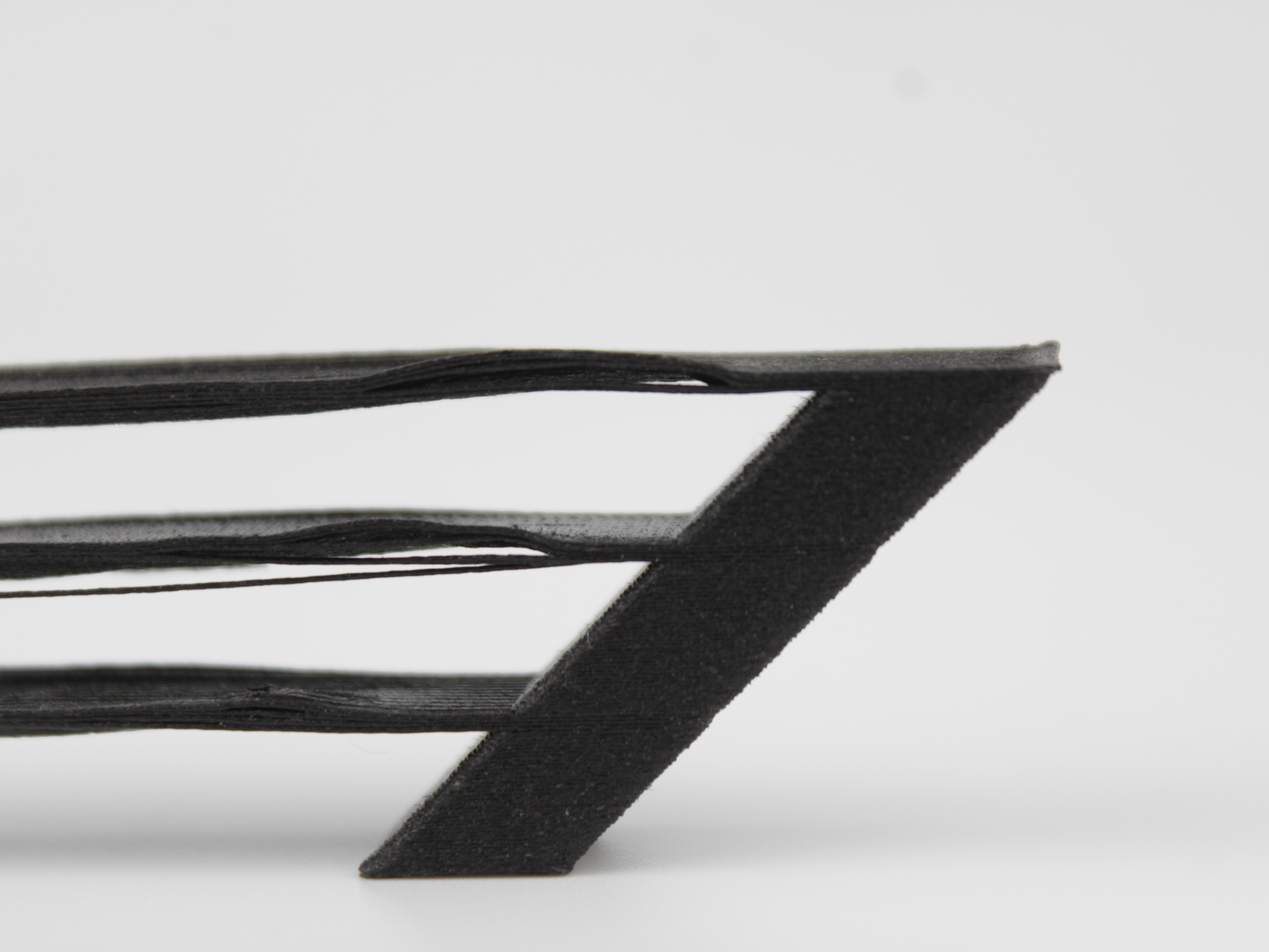 Close-up of sagging bridge strands drooping below the intended plane