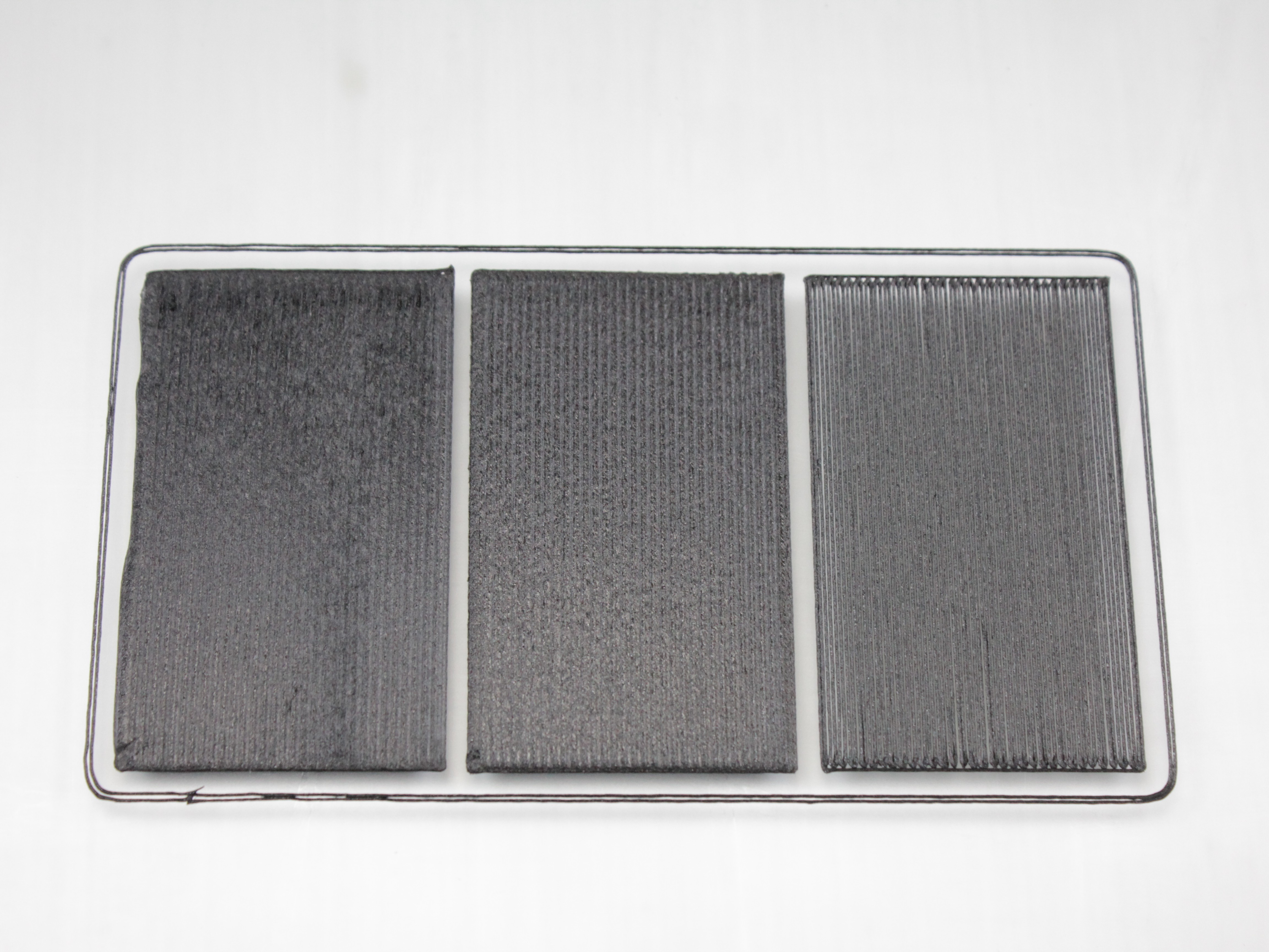 Three first-layer test patches printed side by side: Z too low on the left, correct in the middle, Z too high on the right