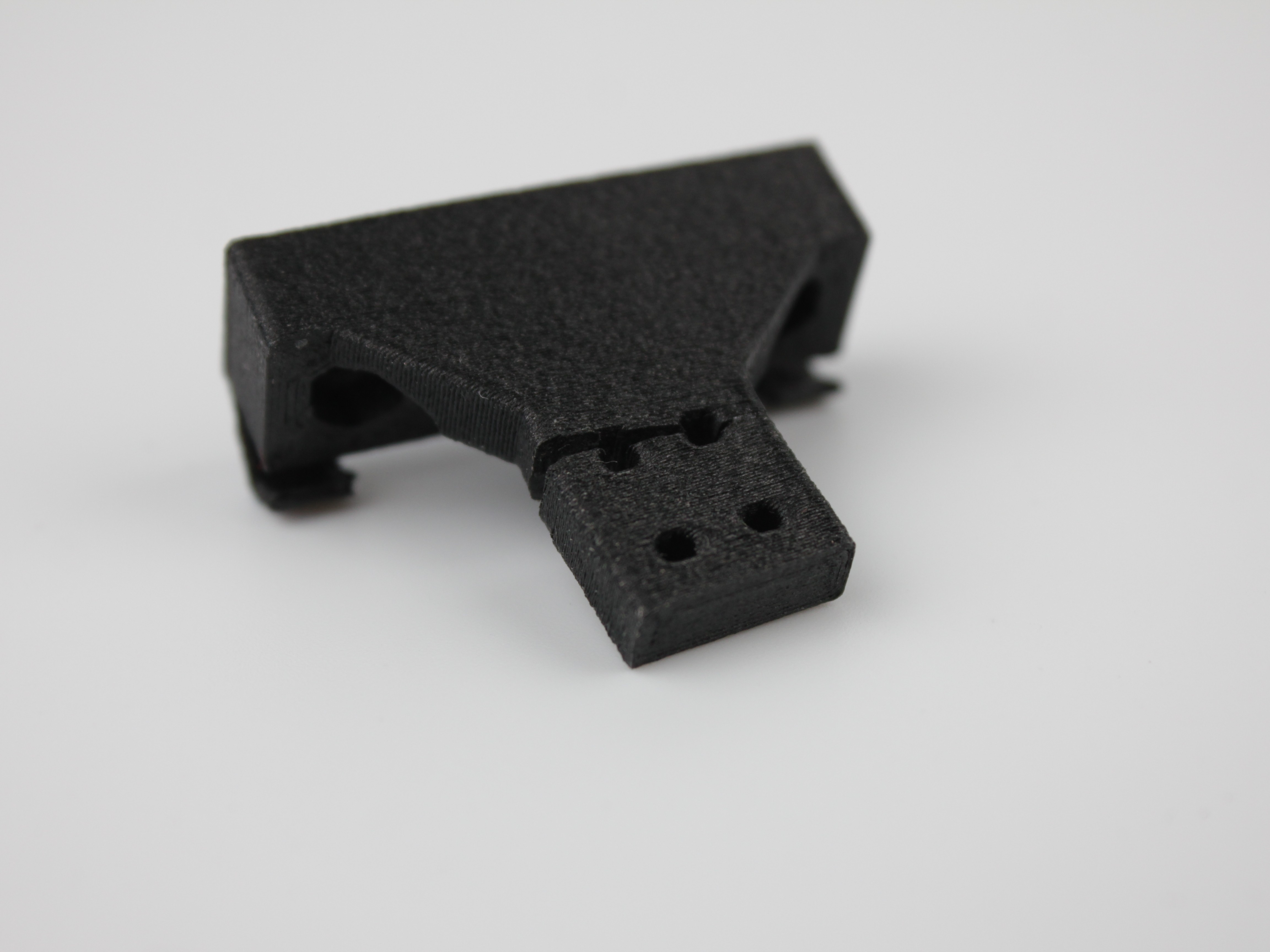 3D-printed Y-axis endstop holder showing inspection for cracks or damage.