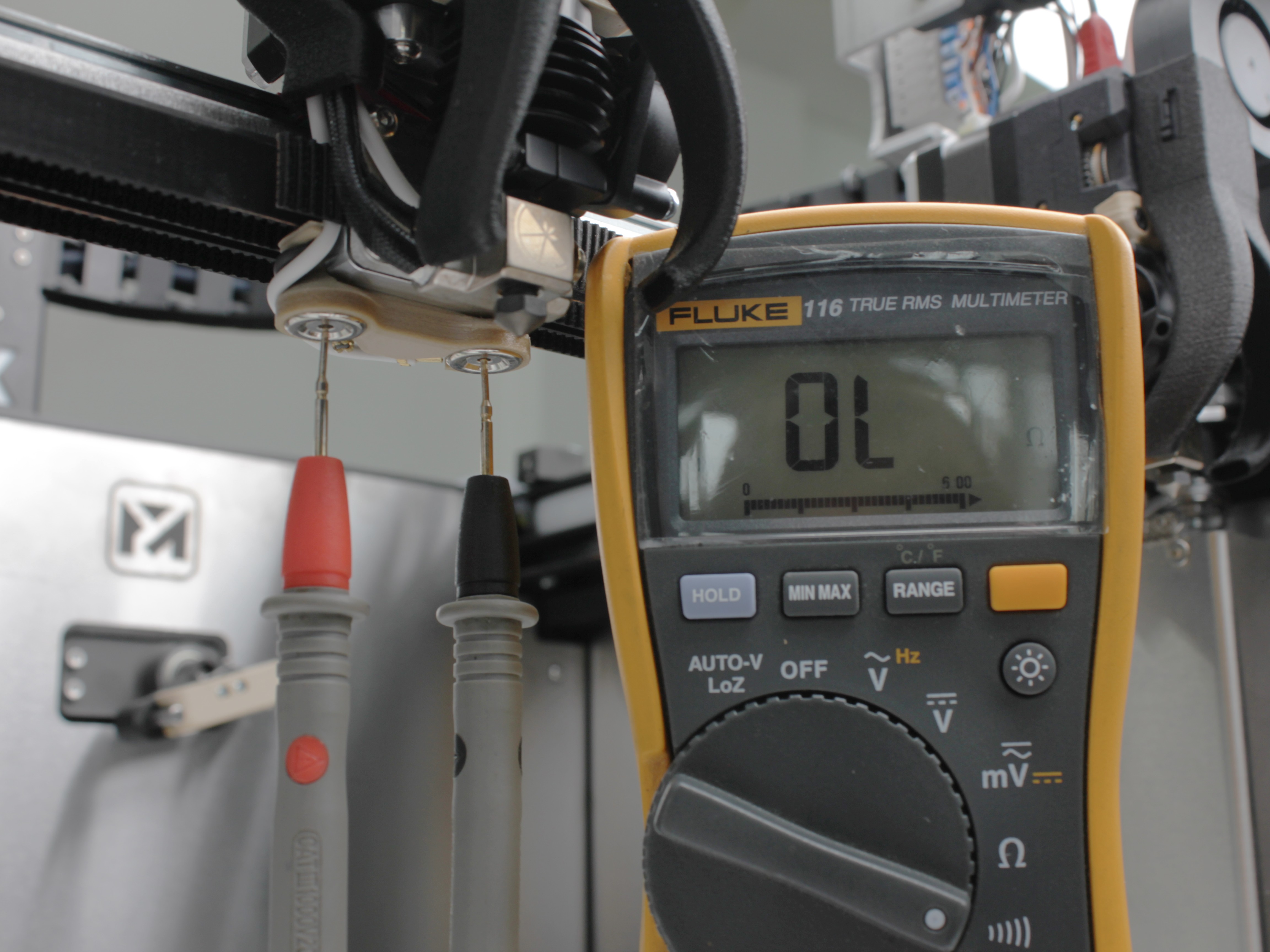 Multimeter probes on Z-Probe body magnet contacts for continuity check