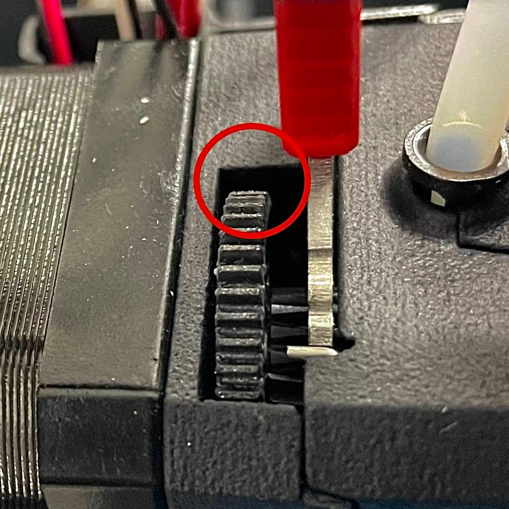 Applying grease to the teeth of the extruder drive gear