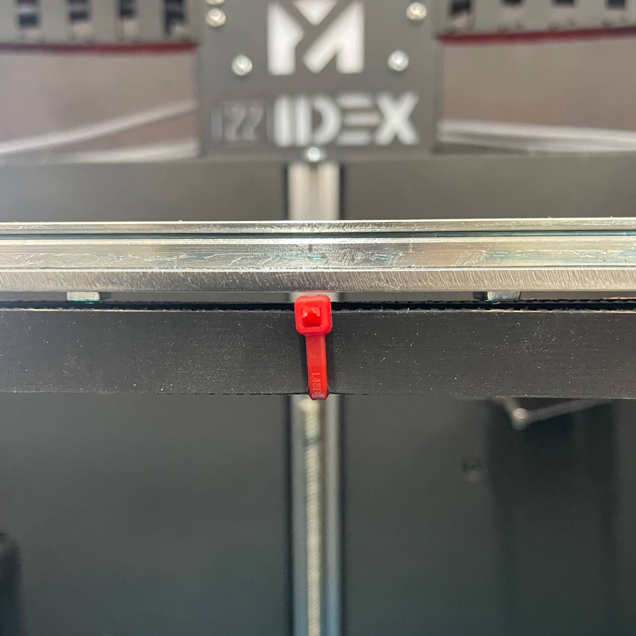 Red zip ties on belts to remove