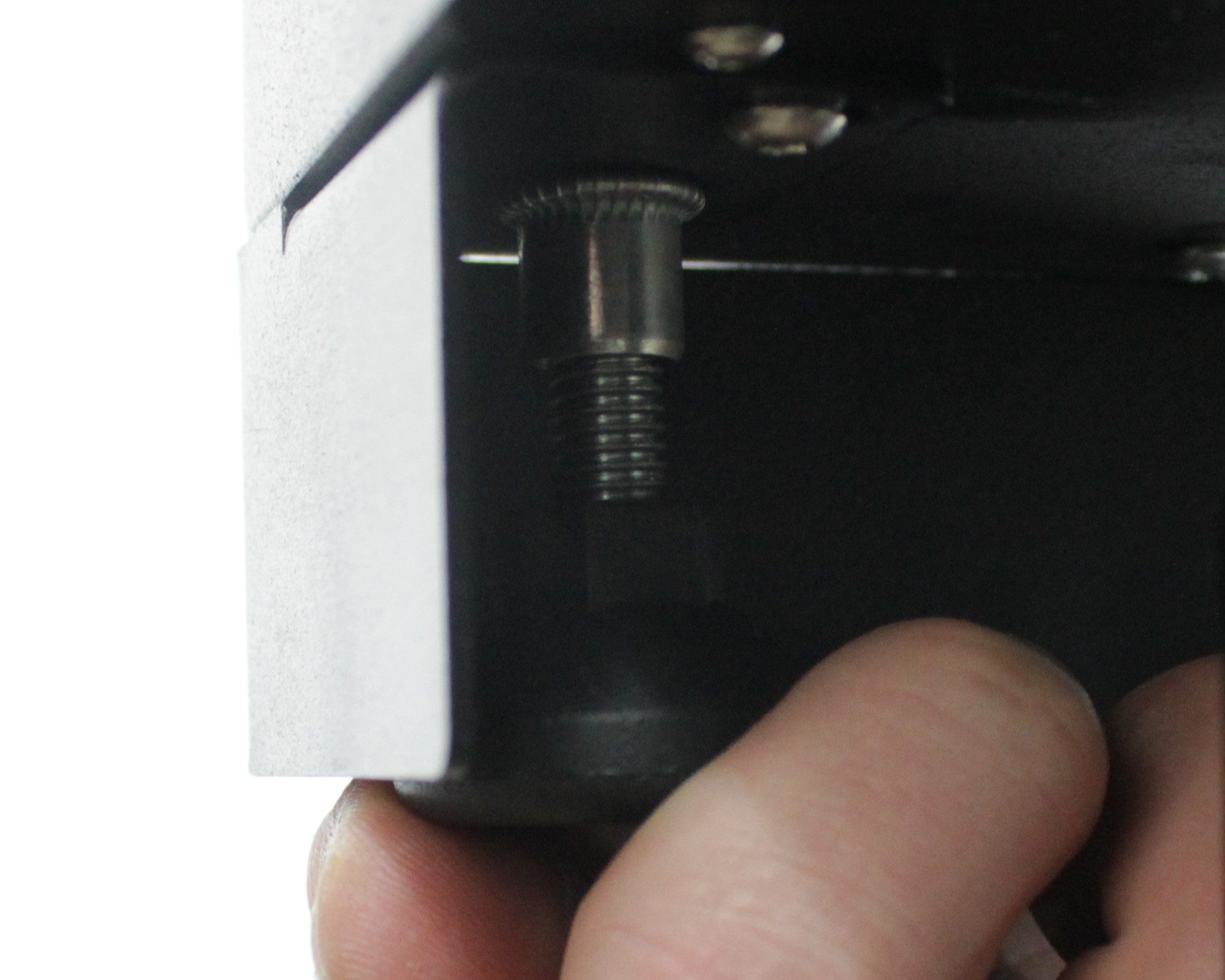 Adjusting leveling feet at printer corner