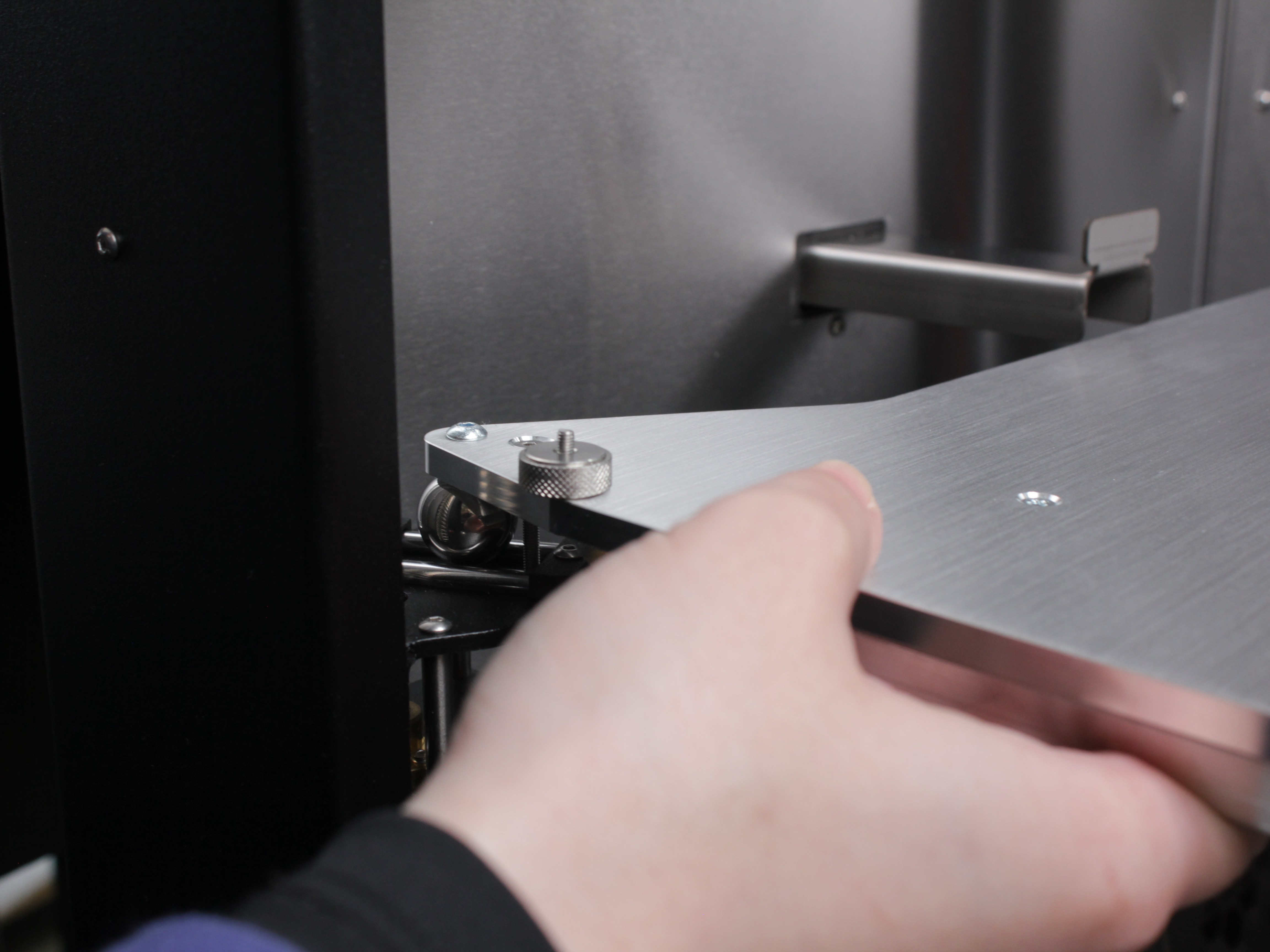 Checking bed play - gently lift the bed upward at each screw location