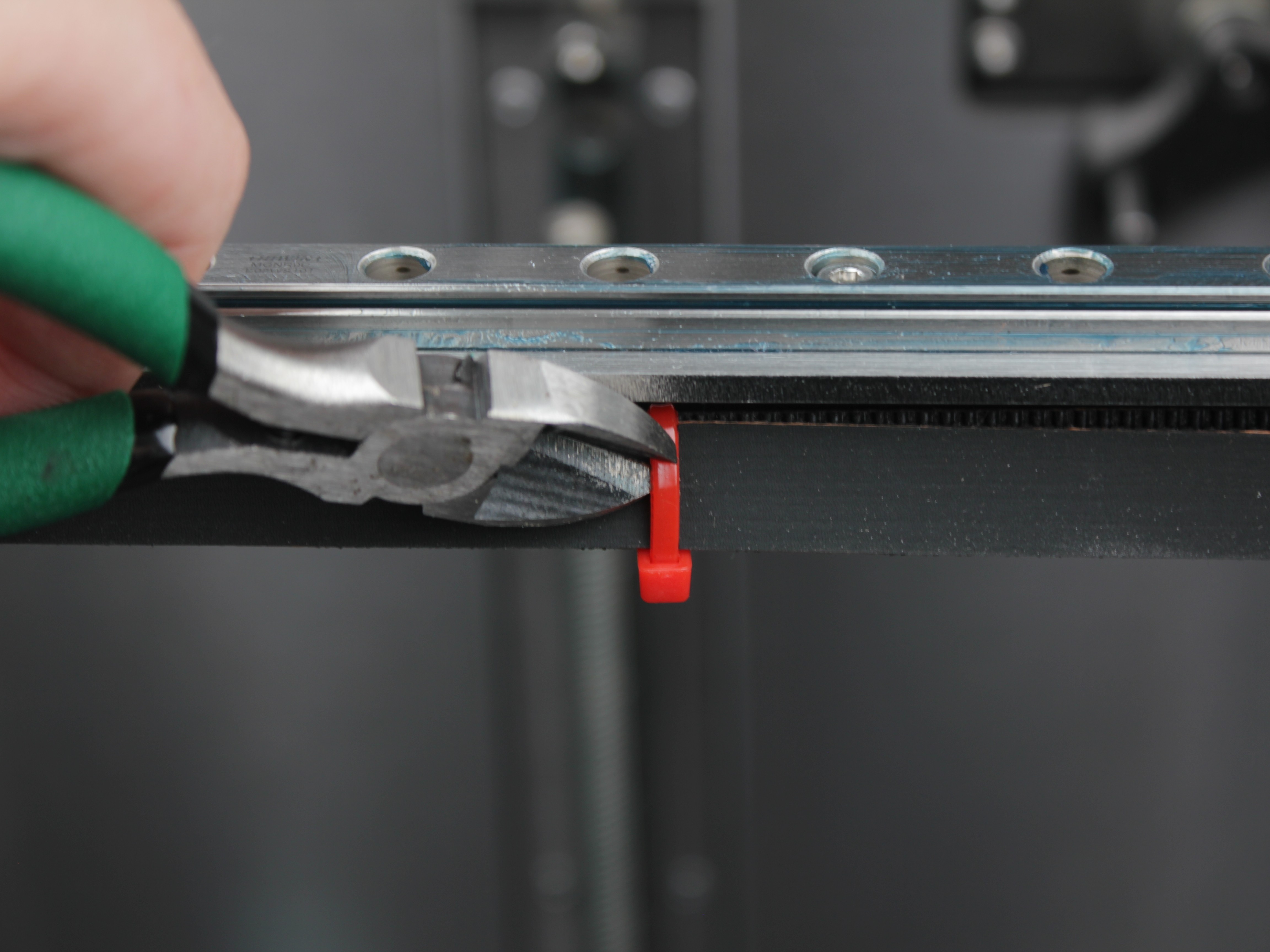 Cutting red zip tie securing tool 2 belt in center