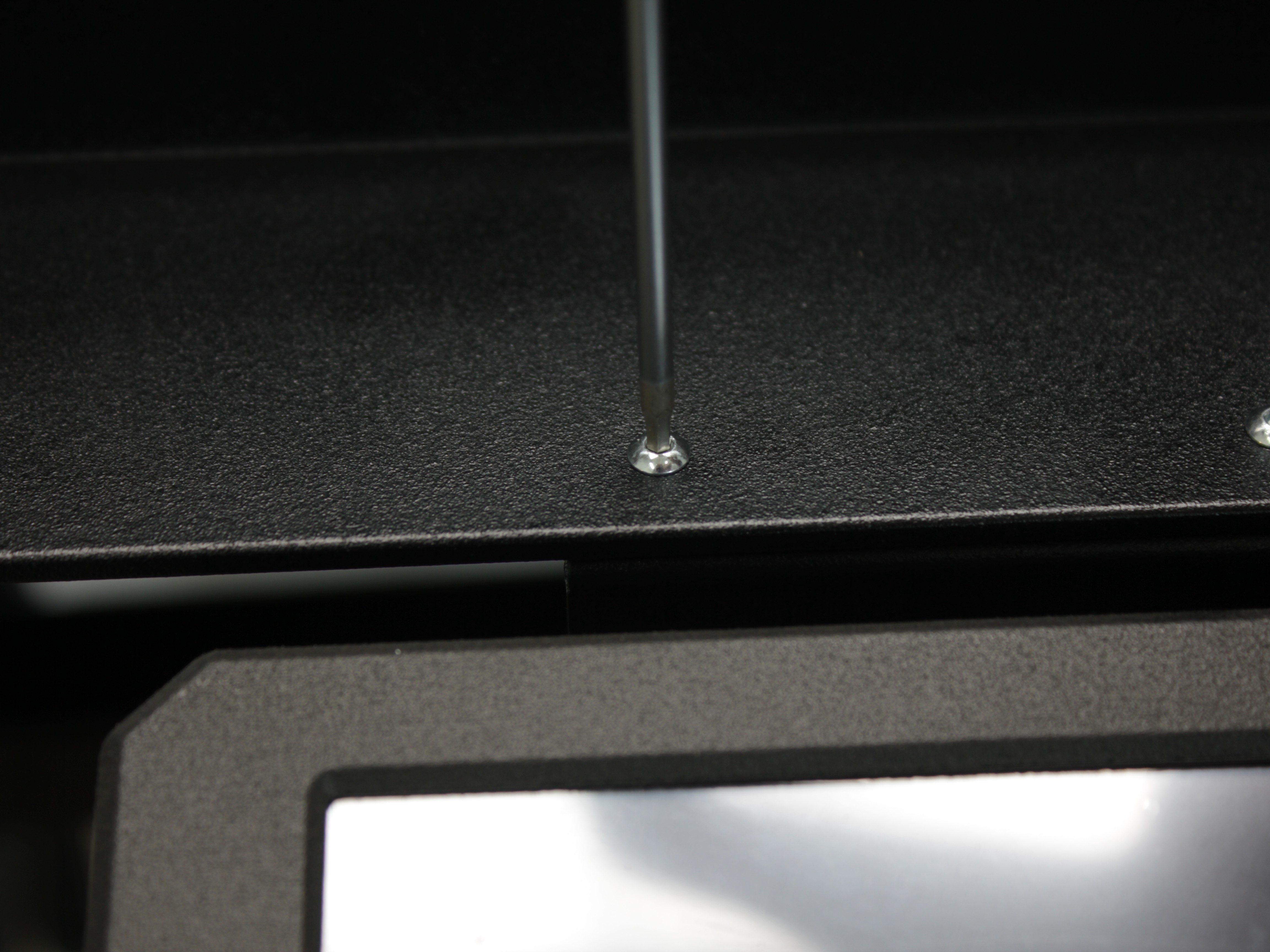 Securing touchscreen with screw from top using 2 mm hex screwdriver